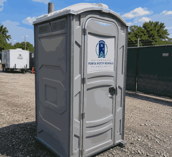 Deluxe flushing porta potty rental unit with vent stack on a Tampa work site